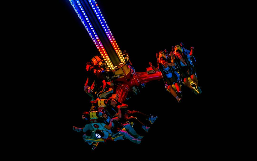 Illuminated amusement park ride at night; illustrative image, not the specific ride involved