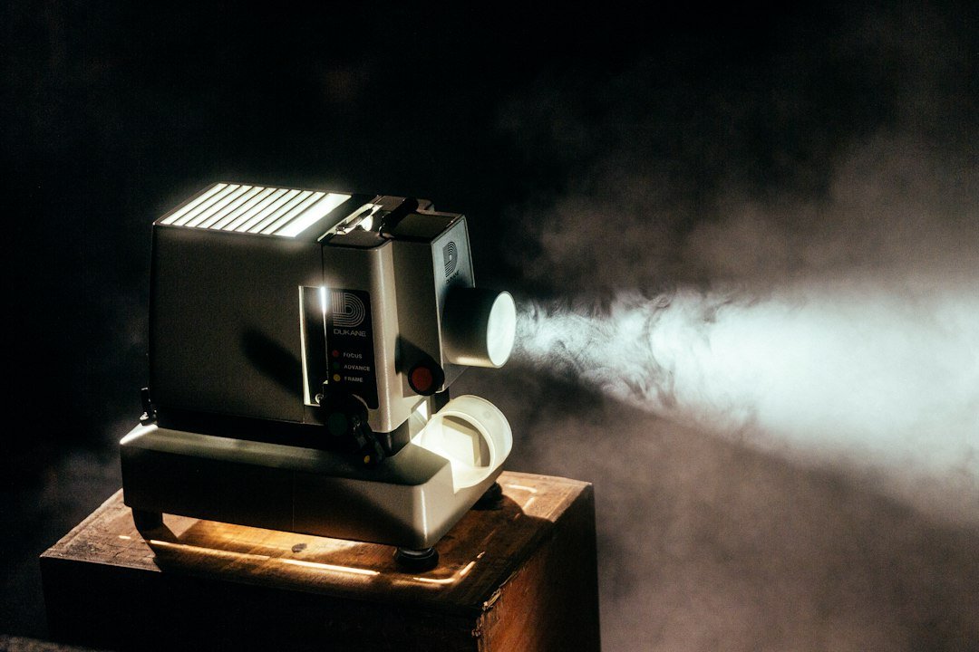 A movie projector in a dark cinema, representing the legacy of classic film and television.